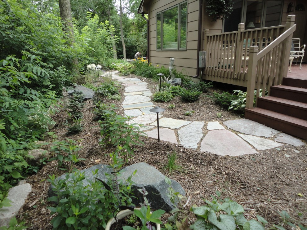 This is an example of a mid-sized traditional backyard stone garden path in Minneapolis.
