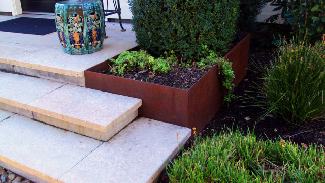 Stone veneered stairs designed to accommodate fabricated corten planter ...