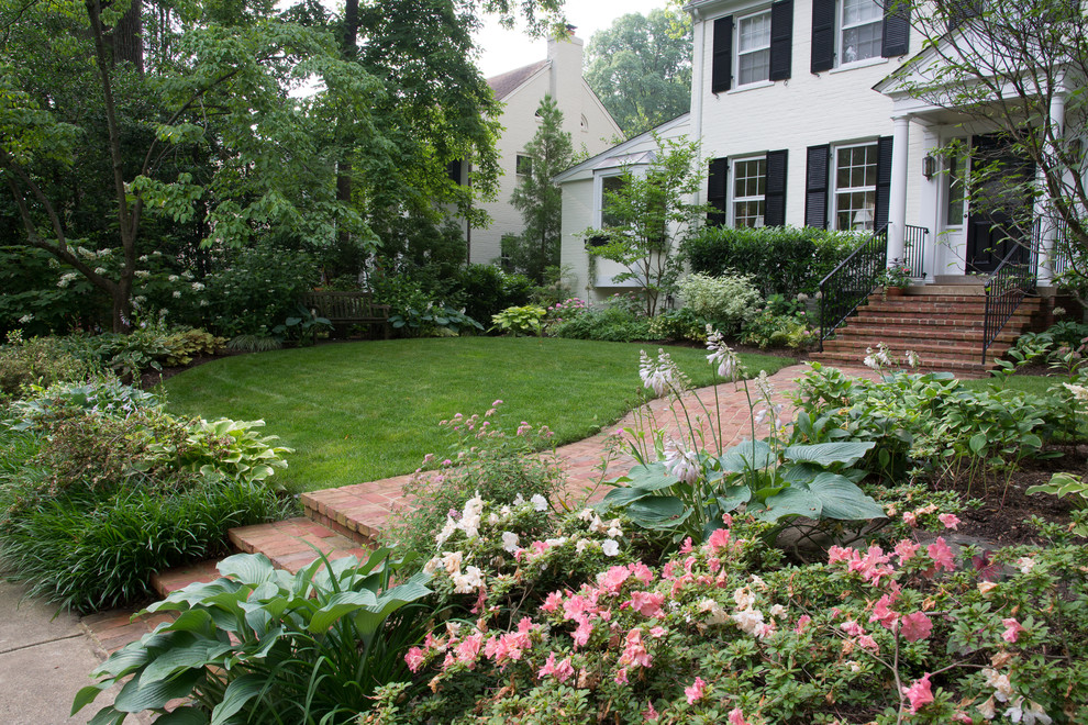 Design ideas for a mid-sized traditional partial sun front yard brick landscaping in DC Metro for spring.