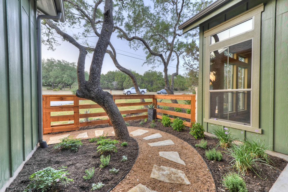 Rustikaler Gartenweg neben dem Haus mit Natursteinplatten in Austin