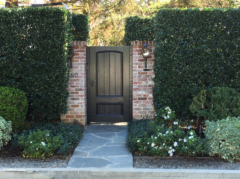 Inspiration for a mid-sized traditional shade front yard stone landscaping in Los Angeles.
