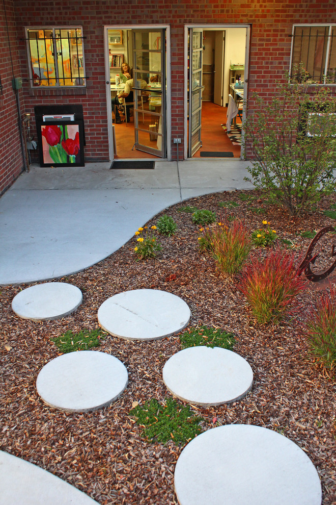 This is an example of a contemporary courtyard concrete paver landscaping in Denver.