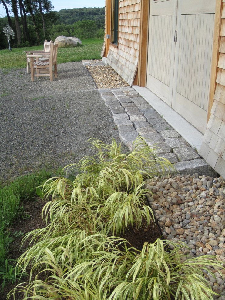 Ejemplo de camino de jardín de secano clásico de tamaño medio en verano en patio lateral con exposición reducida al sol y gravilla