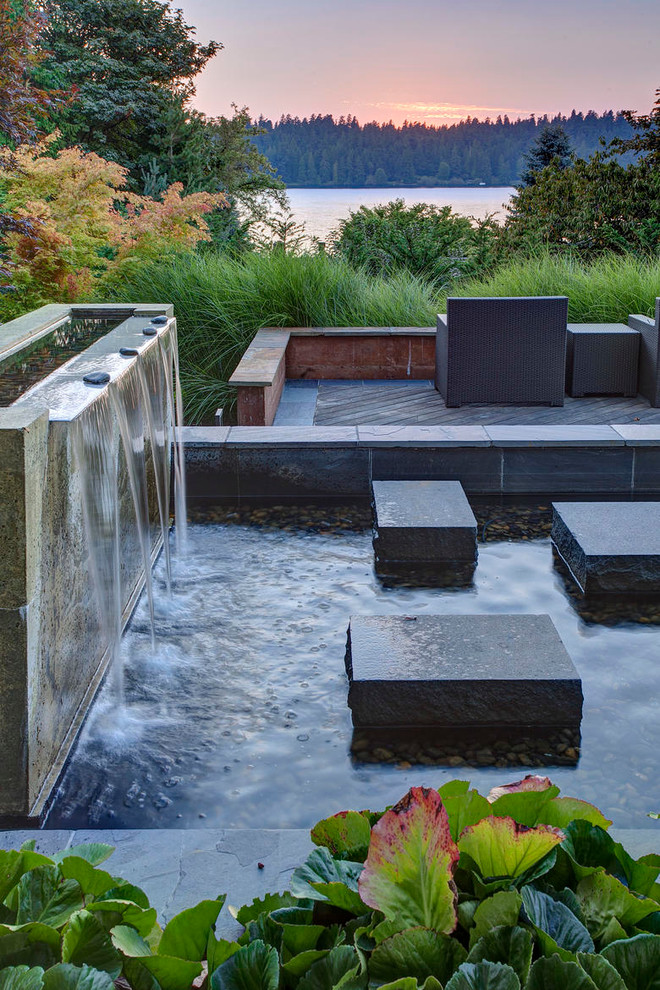 Photo of a contemporary garden in Seattle with a water feature.