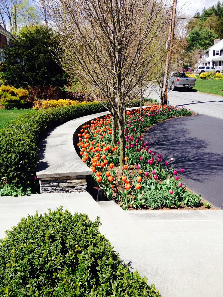 This is an example of a mid-sized traditional full sun front yard stone landscaping in Boston.
