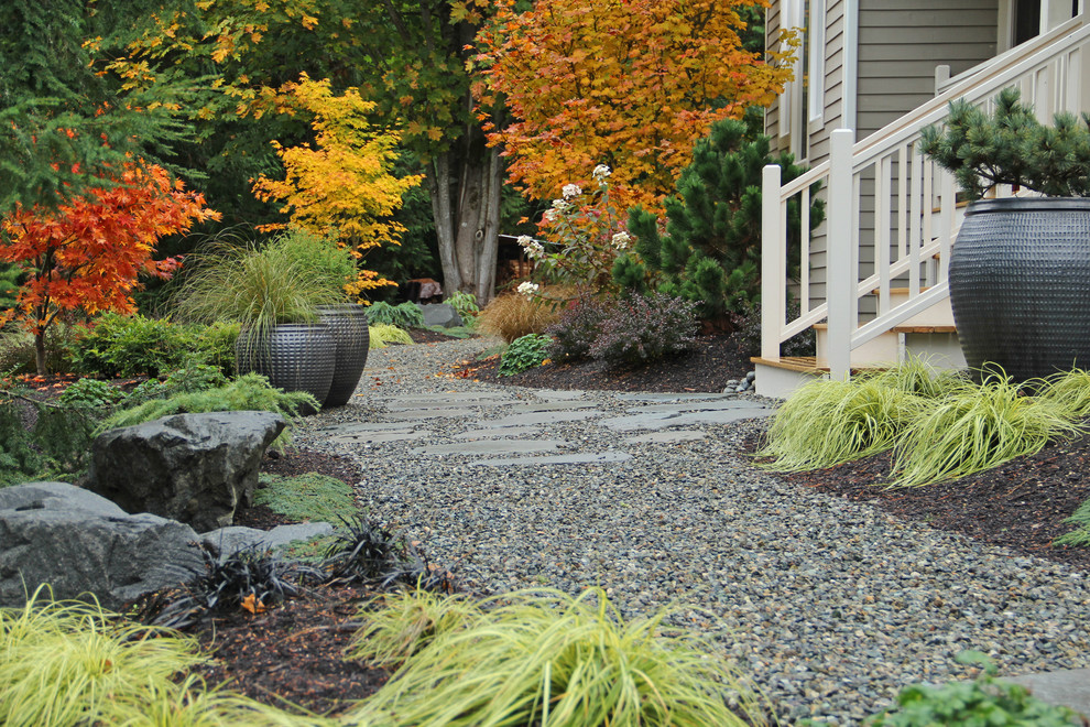 Contemporary garden for autumn in Seattle with a potted garden and gravel.