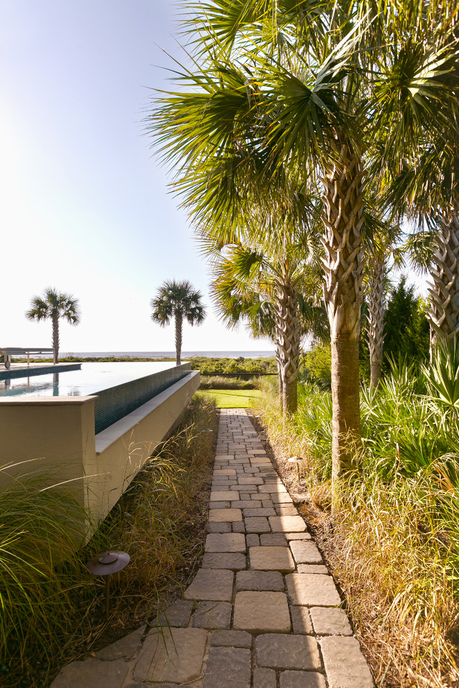 This is an example of a coastal partial sun side yard concrete paver garden path in Charleston.
