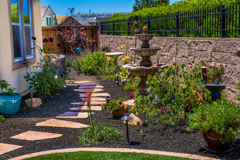 This is an example of a mid-sized transitional partial sun backyard mulch landscaping in San Francisco.