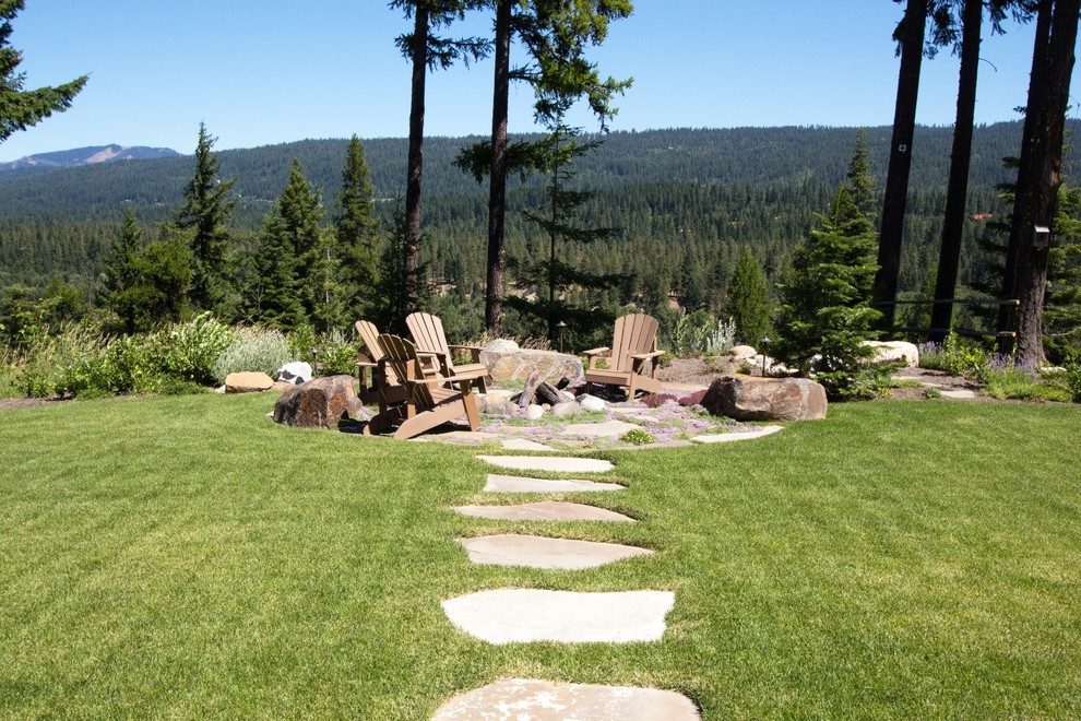 Design ideas for a rustic back full sun garden in Seattle with a fire feature and natural stone paving.