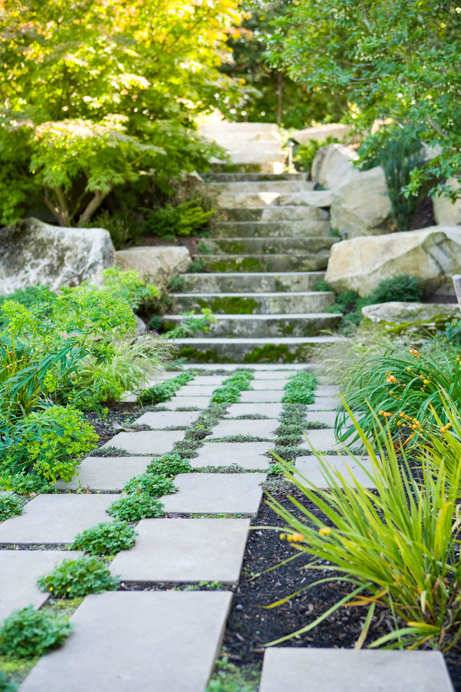 This is an example of a medium sized traditional back formal partial sun garden in Seattle with a garden path and natural stone paving.