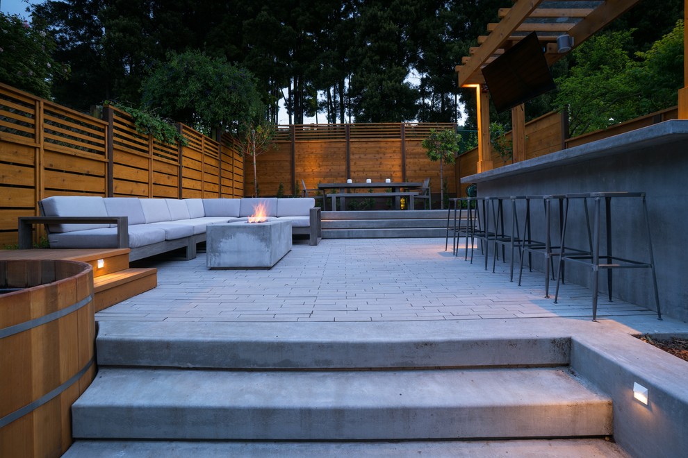 Small minimalist backyard concrete paver patio photo in San Francisco with a fire pit