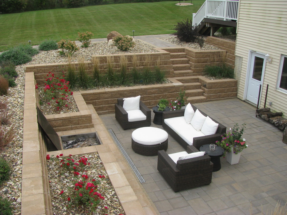 Inspiration for a large traditional side yard concrete paver retaining wall landscape in Minneapolis.