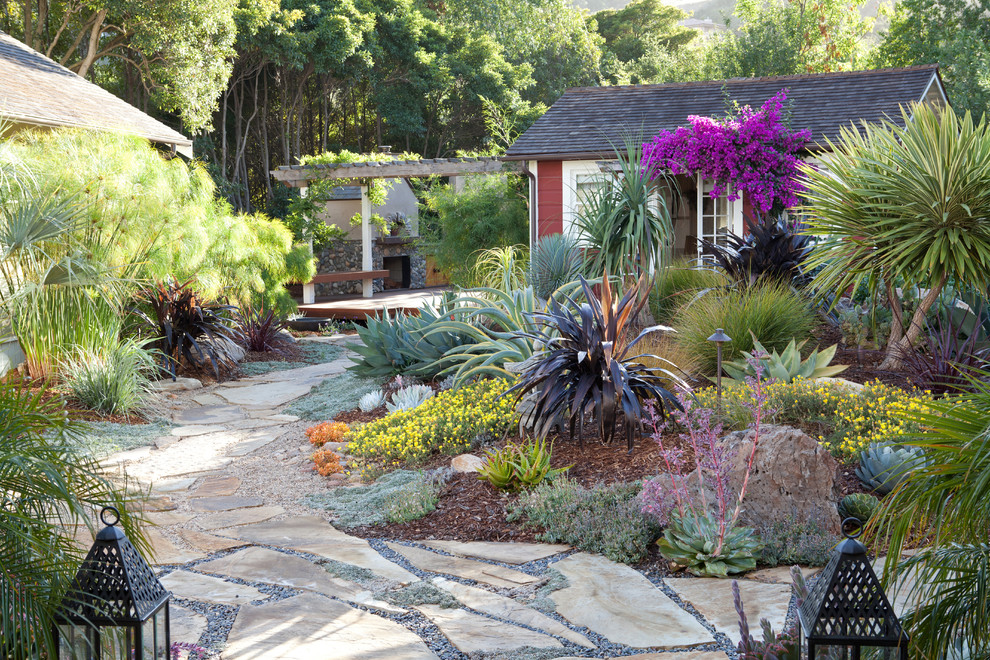 Inspiration for a mediterranean drought-tolerant backyard stone landscaping in San Luis Obispo.