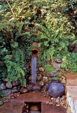 Inspiration for a mid-sized rustic drought-tolerant and full sun courtyard stone water fountain landscape in San Francisco for summer.