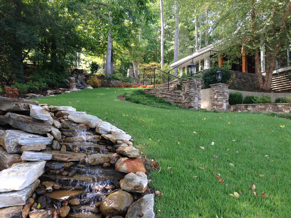 Photo of a rustic full sun side yard stone landscaping in Other.