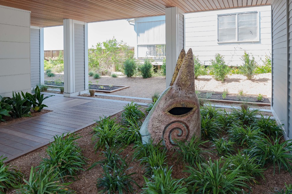 This is an example of a large coastal courtyard landscaping in Wilmington.