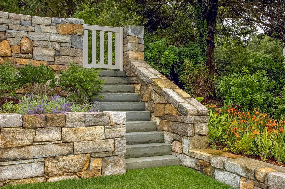 Inspiration for a large modern sloped formal full sun garden for summer in Boston with a retaining wall and natural stone paving.