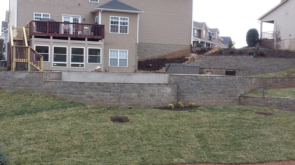 Swimming pool project with retaining walls and patio Traditional