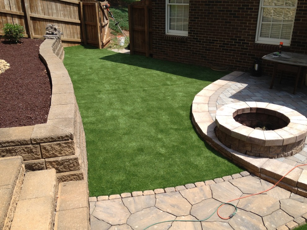 Photo of a small traditional full sun courtyard concrete paver landscaping in Charlotte for summer.
