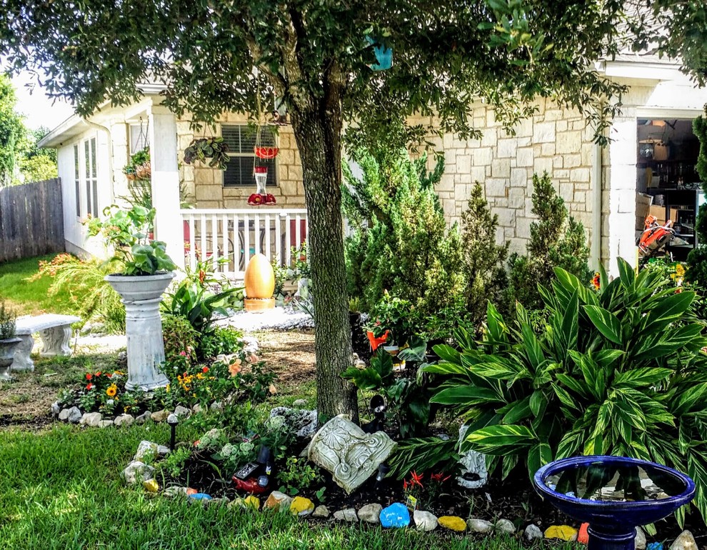 Idéer för en liten eklektisk formell trädgård i delvis sol framför huset på våren, med en trädgårdsgång och naturstensplattor