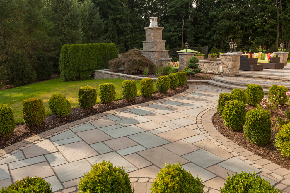 This is an example of a large traditional full sun front yard stone landscaping in Philadelphia for spring.