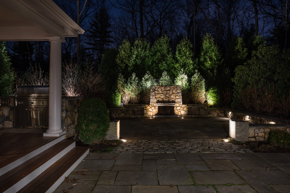 Photo of a large traditional full sun backyard stone landscaping in Boston with a fire pit.