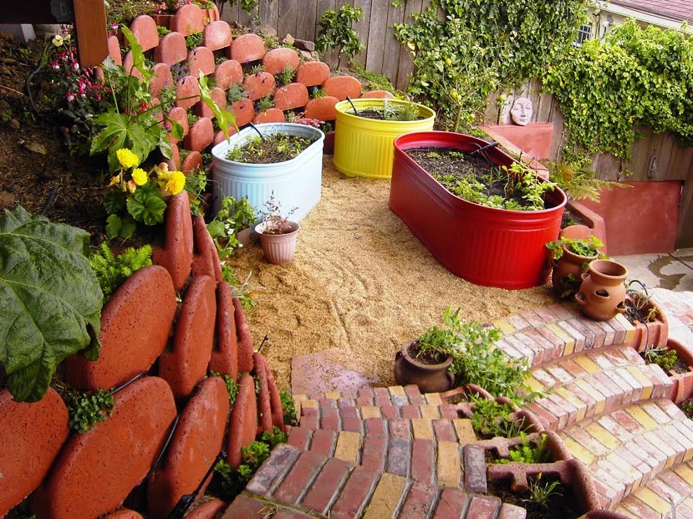 Design ideas for a small world-inspired back xeriscape partial sun garden steps in San Francisco with brick paving.