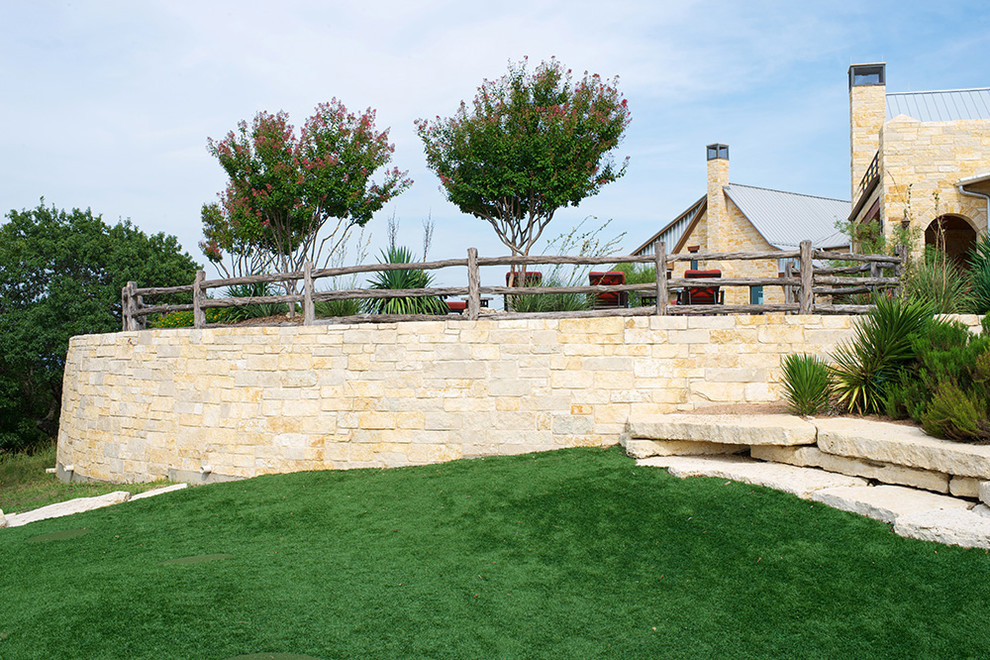 Geräumige Rustikale Gartenmauer hinter dem Haus mit direkter Sonneneinstrahlung und Natursteinplatten in Dallas