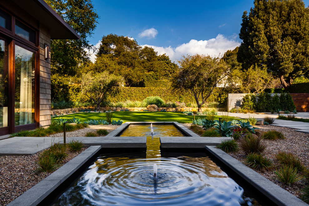 This is an example of a contemporary garden in Santa Barbara with a water feature.