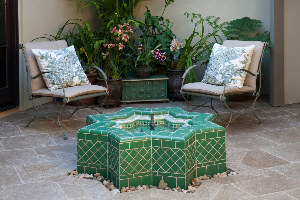 Design ideas for a mid-sized mediterranean courtyard water fountain landscape in Santa Barbara.