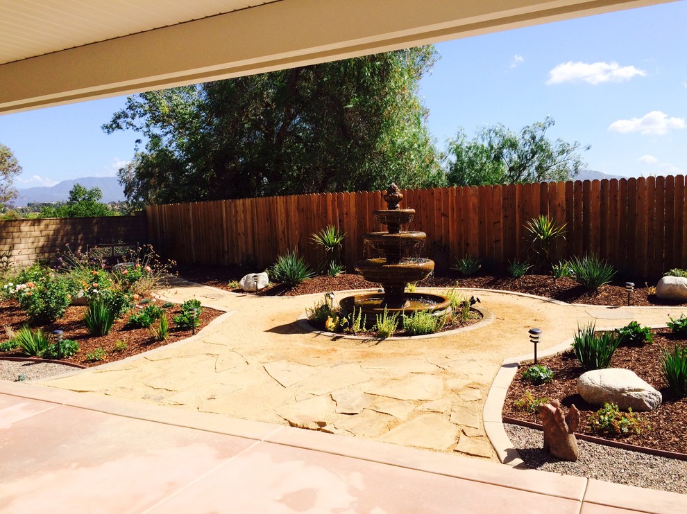 Design ideas for a medium sized eclectic back patio in San Diego with a water feature and gravel.