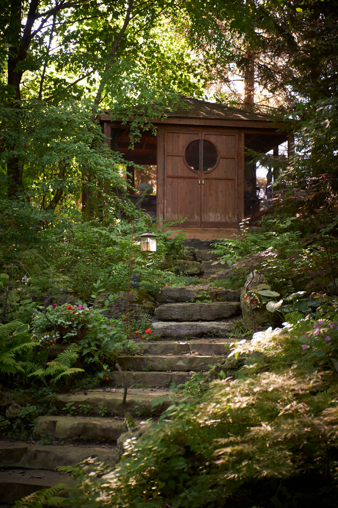 This is an example of a rustic sloped garden in Toronto.