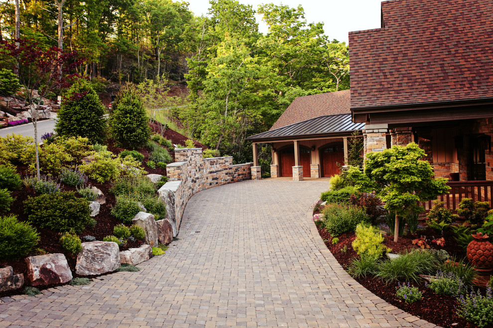 Photo of a medium sized traditional sloped driveway full sun garden for summer in Charlotte with concrete paving.