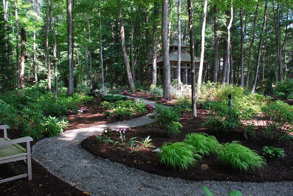 This is an example of a large world-inspired fully shaded garden in Burlington with a garden path.