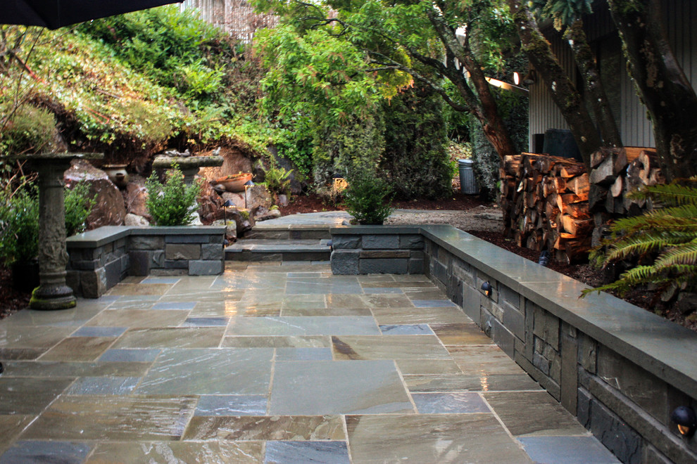 Traditional back formal garden in Seattle with natural stone paving.