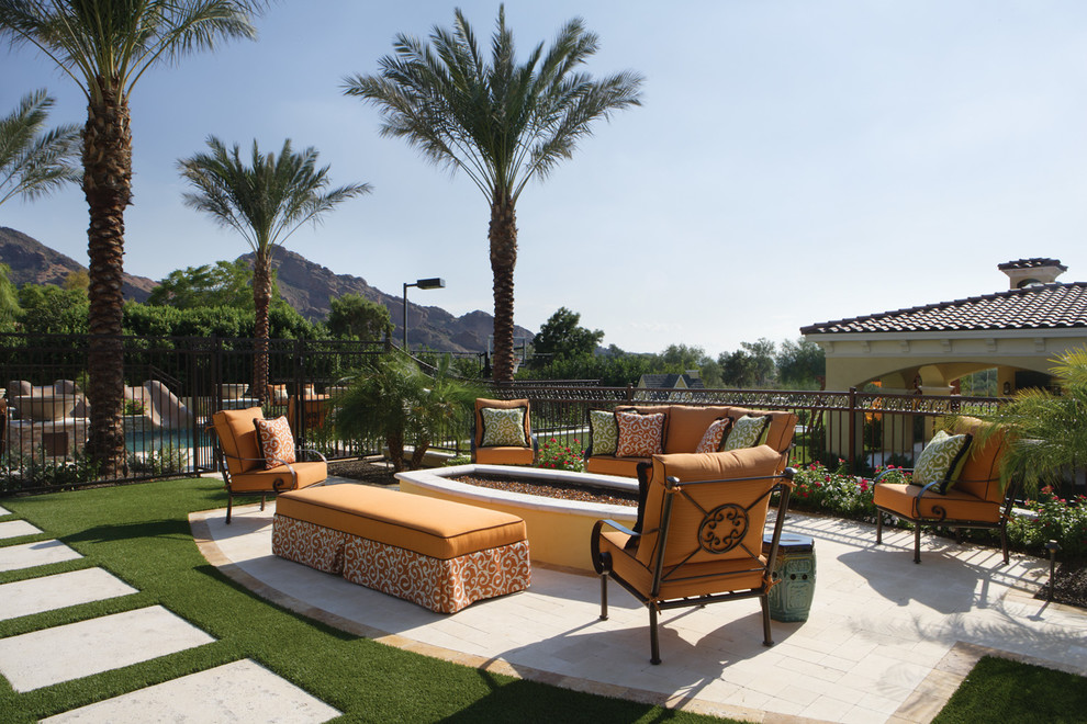 Photo of an expansive mediterranean back partial sun garden for autumn in Phoenix with a water feature and natural stone paving.