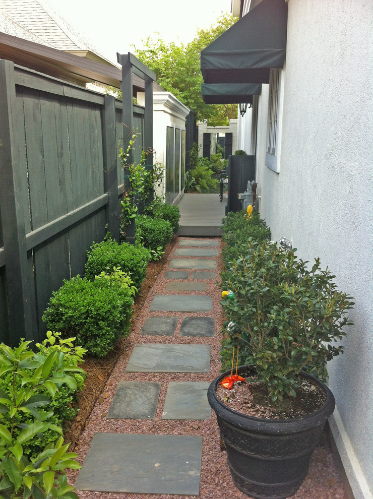 Small classic courtyard fully shaded garden in New Orleans with natural stone paving.
