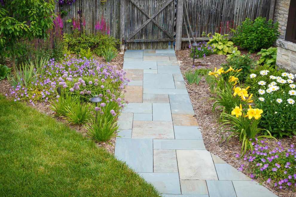 Design ideas for a large traditional backyard stone garden path in Milwaukee.