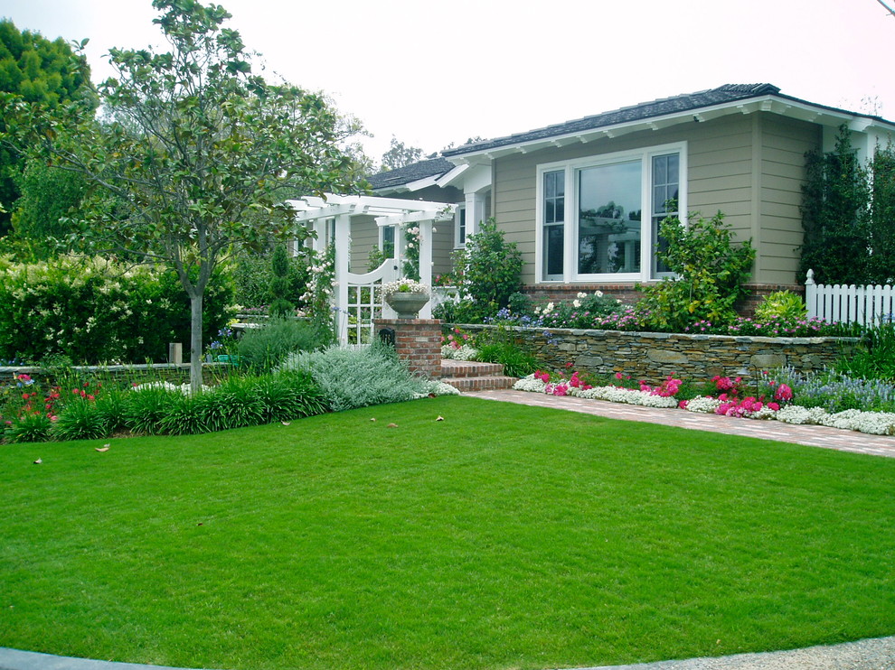 Inspiration for a traditional full sun front yard brick landscaping in San Diego.