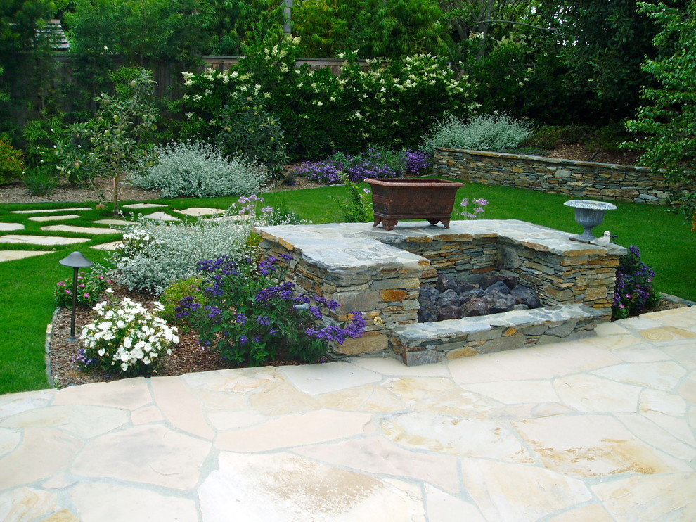Design ideas for a classic back full sun garden in San Diego with a fire feature and natural stone paving.