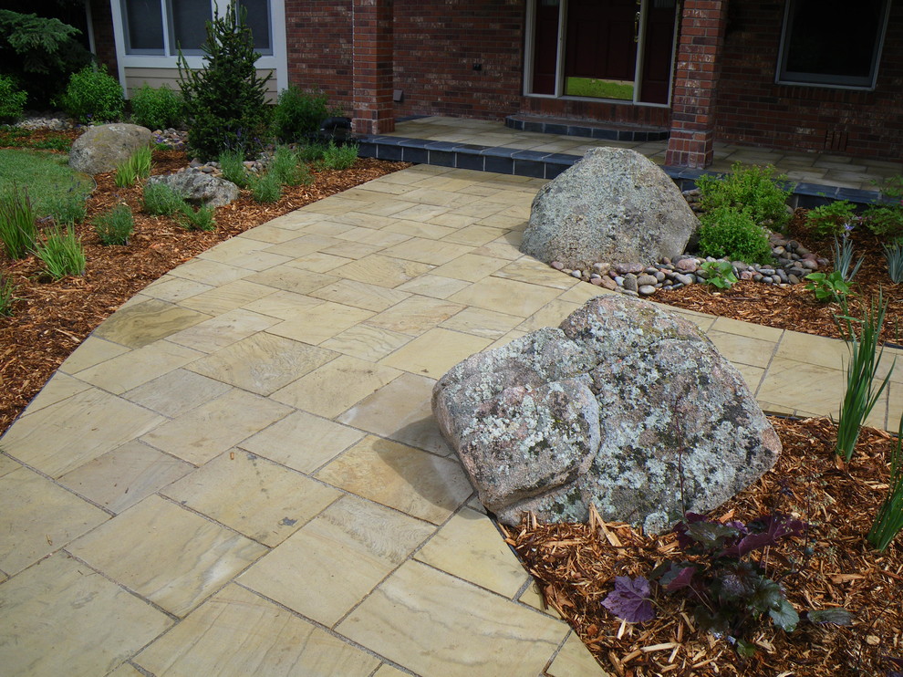 Design ideas for a small traditional partial sun front yard stone driveway in Denver.