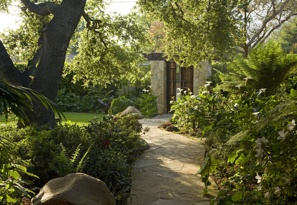 Classic fully shaded garden in Santa Barbara with natural stone paving.