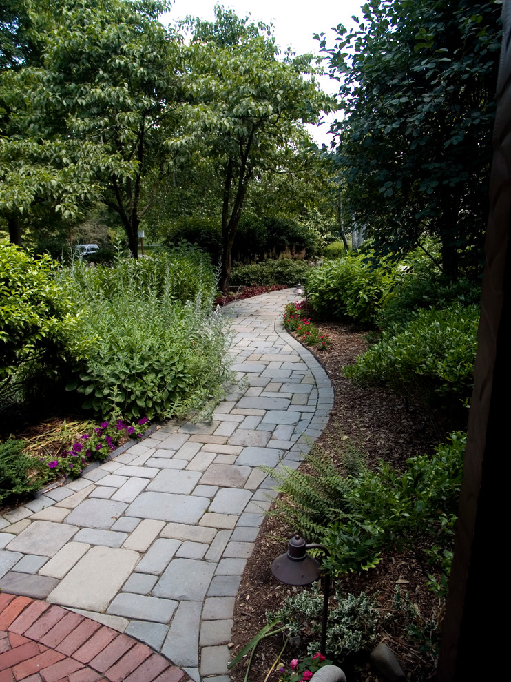 Photo of a traditional concrete paver garden path in New York.