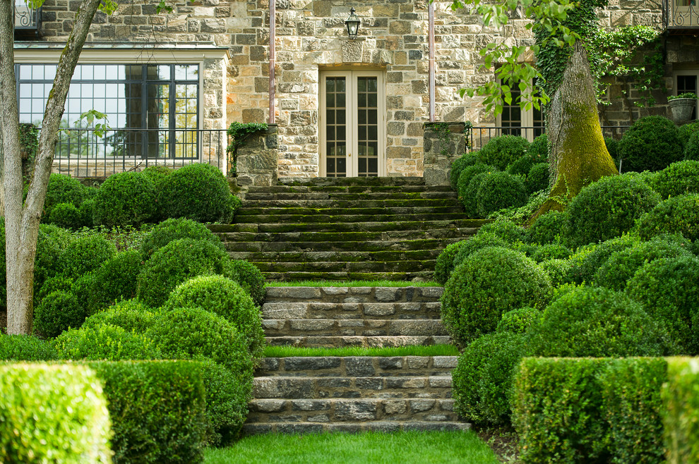 Inspiration for a traditional sloped garden steps in New York with natural stone paving.