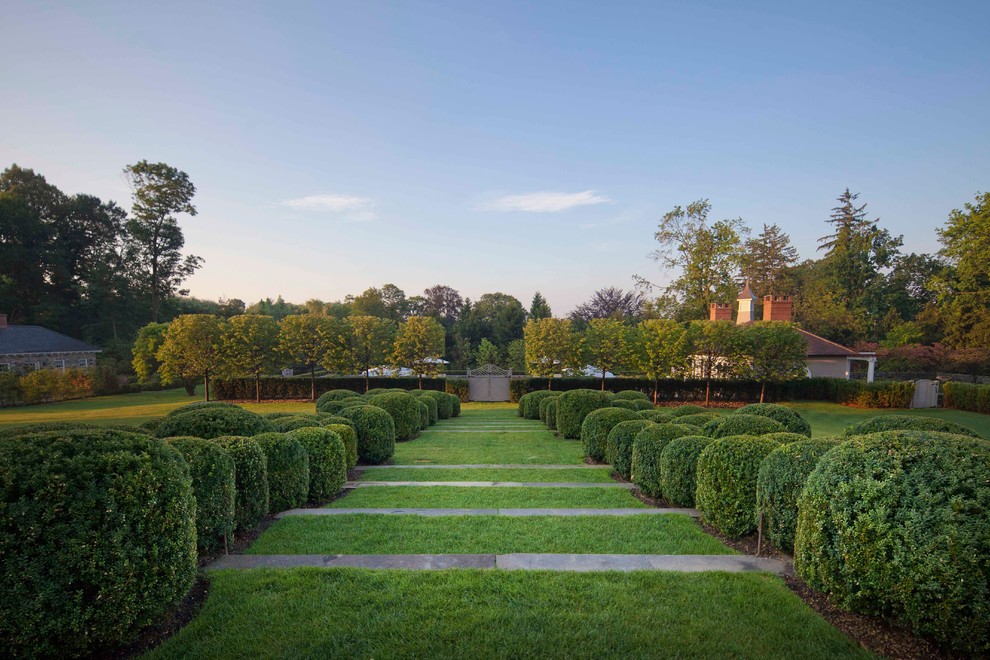 На фото: огромный регулярный сад на заднем дворе в классическом стиле