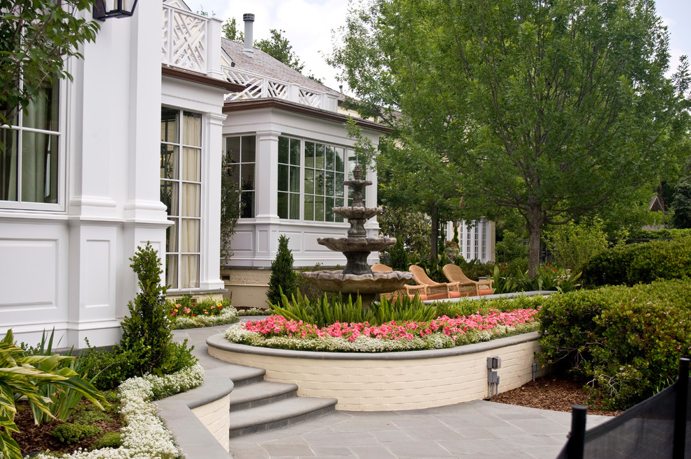 This is an example of a large traditional partial sun backyard water fountain landscape in Dallas.
