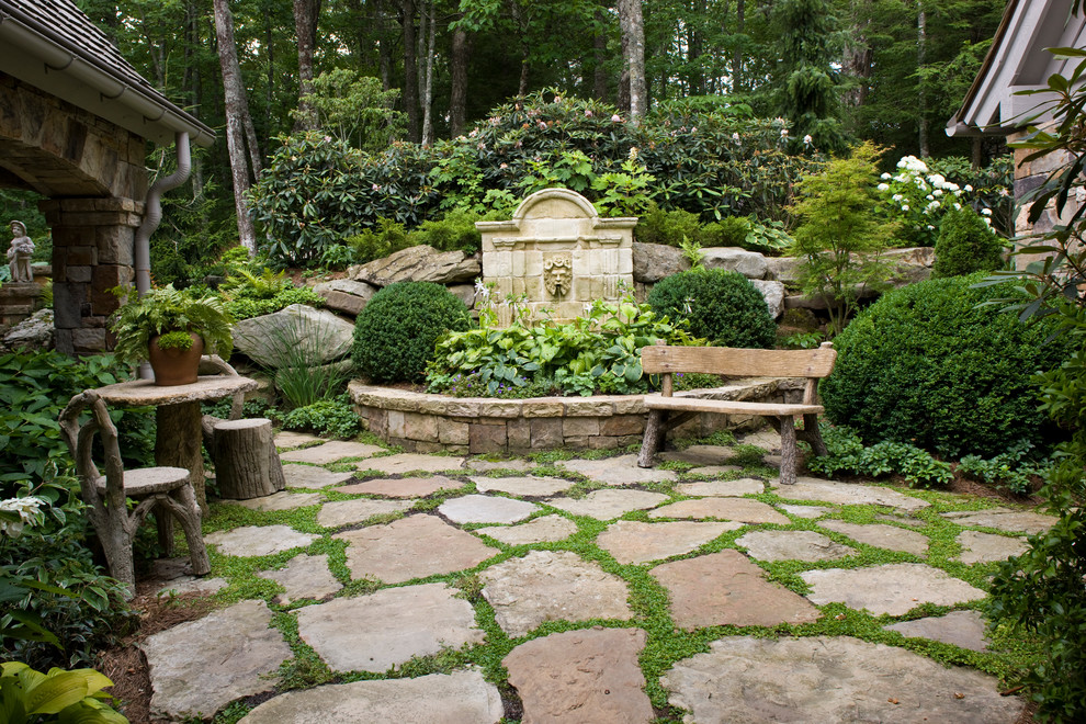 This is an example of a traditional back fully shaded garden in Atlanta with natural stone paving.