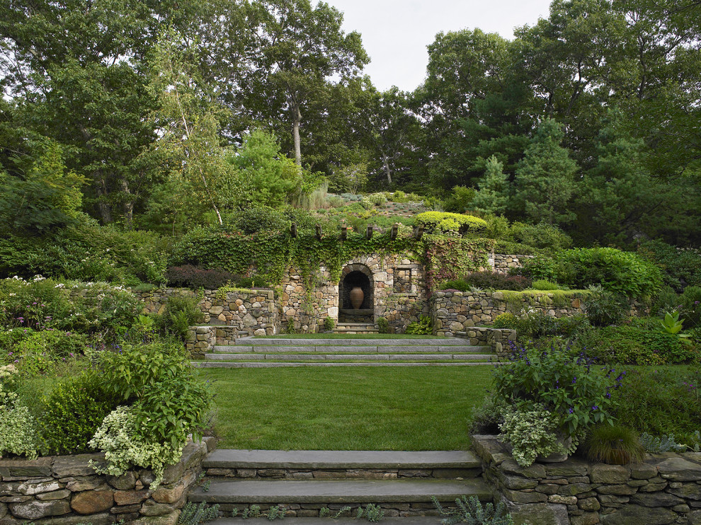Photo of a traditional garden in Boston with a retaining wall.
