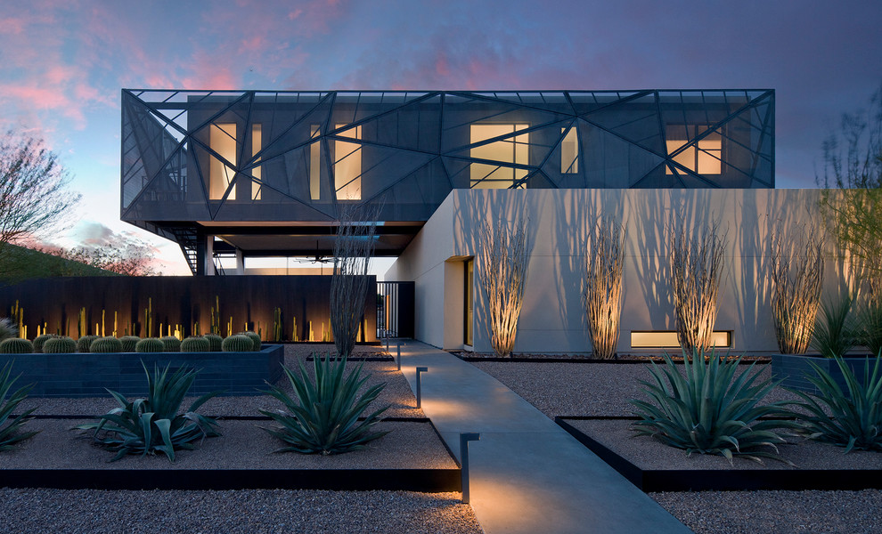 This is an example of a contemporary drought-tolerant and full sun front yard gravel landscaping in Las Vegas.