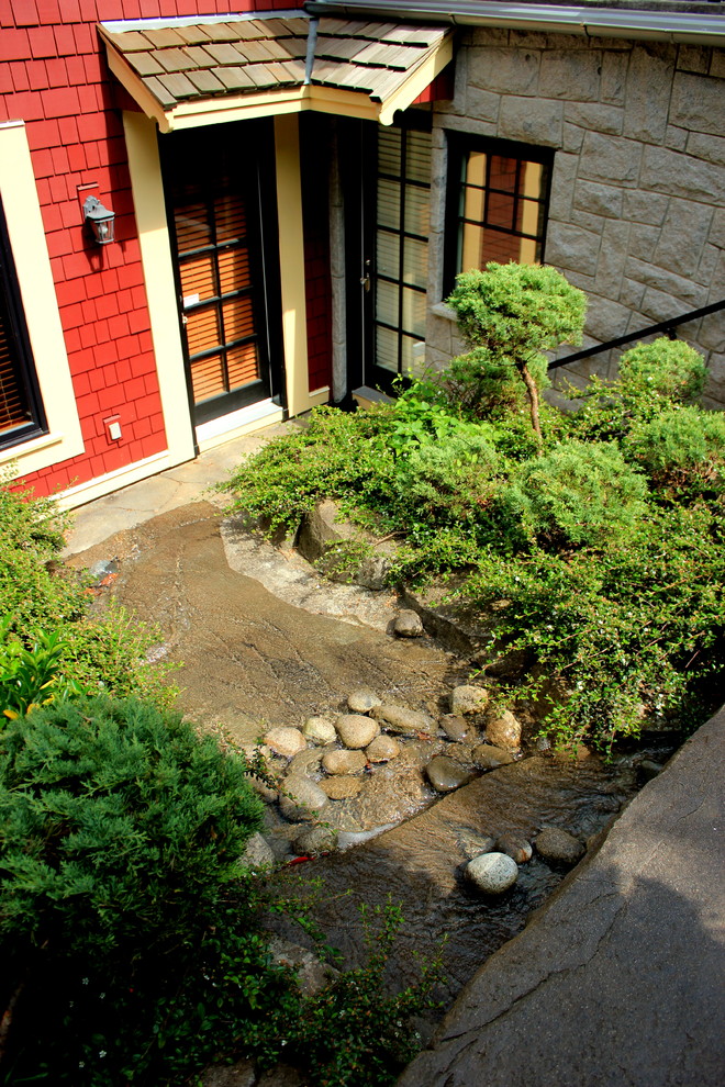 Inspiration for a mid-sized traditional partial sun backyard stone garden path in Vancouver.